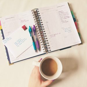 planner and coffee on table