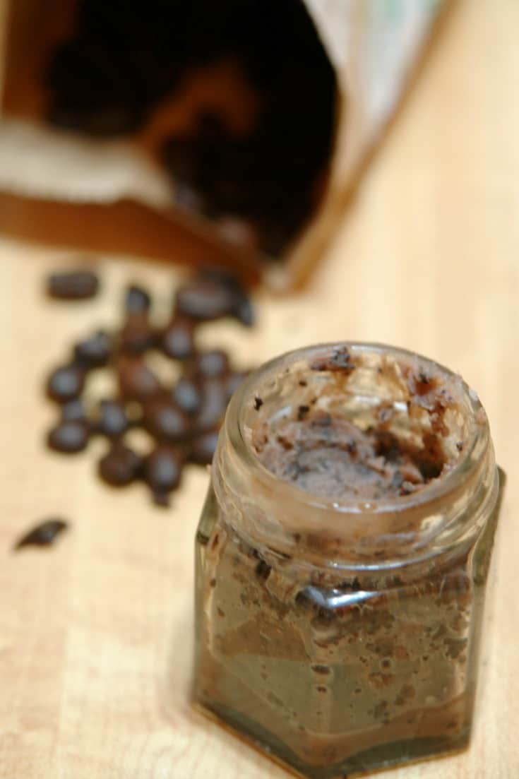 jar of homemade lip scrub on table with bag of coffee in background