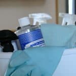 cleaning supplies in white bucket