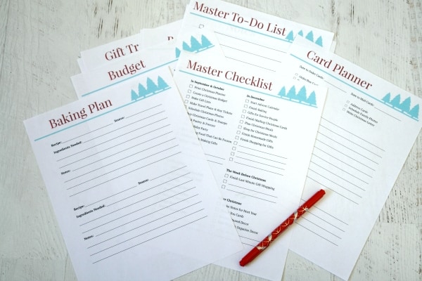 Christmas planner sheets on table with red pen