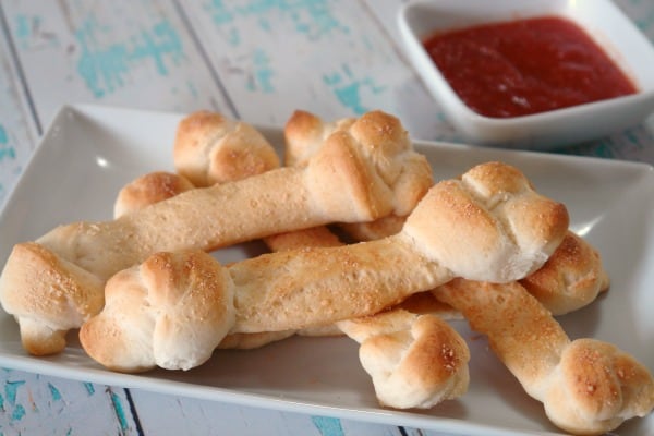 breadstick bones on plate with pizza sauce