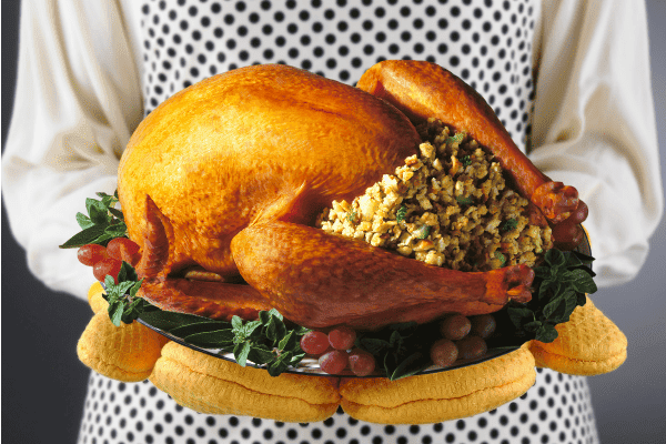 woman holding turkey on platter