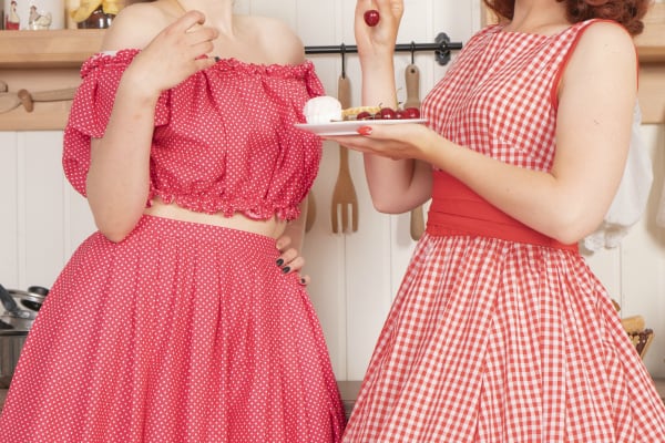 1950s housewives eating treats in kitchen