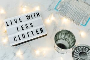 lightbox with "live with less clutter" message and basket and trash bin
