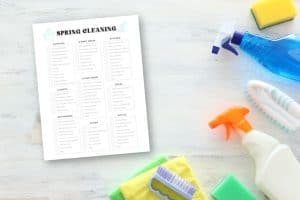 spring cleaning checklist on table with cleaning supplies
