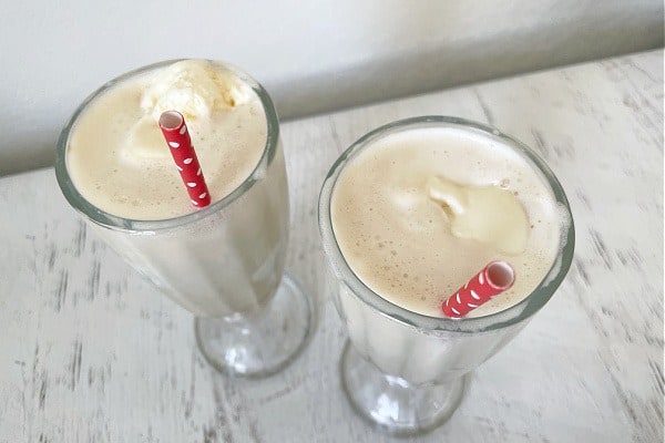 up close shot of coffee floats in glasses with red straws