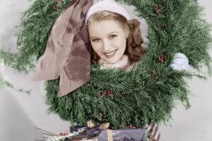 1950s housewife with head in wreath and christmas gifts on table