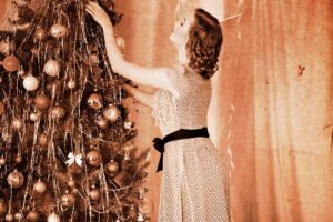 1950s housewife putting tinsel on Christmas tree