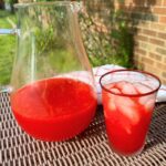 fruit punch in pitcher on table outside overtop view